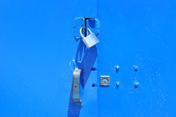 A blue door background with an industrially soldered clasp for the lock to secure the door nicely, representing website security